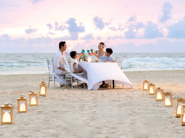 Family enjoys dinner on the beach