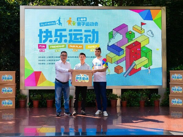 费列罗中国健达品牌市场总监金博源与上海市儿童基金会副理事长、上海市校外教育协会社会教育工作委员会常务副主任陈勇向静安小学校方代表赠送“健达快乐运动”游戏盒子